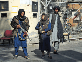 Taliban fighters stand guard at an entrance gate of the Sardar Mohammad Dawood Khan military hospital in Kabul on November 3, 2021, a day after an attack claimed by the Taliban's hardline rivals the Islamic State-Khorasan, in which at least 19 people were killed.