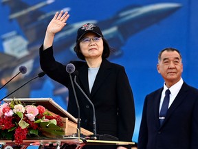 Taiwanese President Tsai Ing-wen participates in a commissioning ceremony for a squadron of upgraded F-16V fighter jets as Defence Minister Chiu Kuo-cheng looks on at the Chiayi Air Force base in southern Taiwan on Nov. 18, 2021.