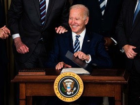 President Biden smiles after signing three bills in the State Dining Room at the White House on November 18, 2021.