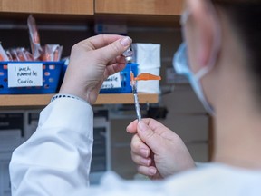 A pharmacist prepares the Pfizer-BioNTech COVID-19 mRNA vaccine at a pharmacy prototype clinic in Halifax on Tuesday, March 9, 2021.