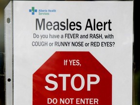 Alberta Health Services confirmed a new case of measles in the heart of west Edmonton. A Measles Alert sign is seen on the door that leads into a Dynalife Diagnostic Lab Services at the Marketplace at Callingwood at 178 St., and 69 Ave.,  in Edmonton Alta., on Wednesday April 23, 2014. Tom Braid/Edmonton Sun/QMI Agency
