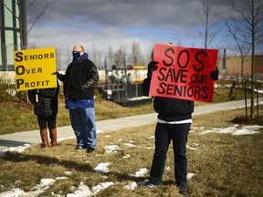 People protest outside the Tendercare Living Centre long-term-care facility during the COVID-19 pandemic in Scarborough, Ont., on Tuesday, December 29, 2020. This LTC home has been hit hard by the coronavirus during the second wave. THE CANADIAN PRESS/Nathan Denette