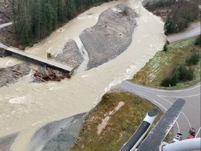 A swollen creek flows under a washed out bridge at the Carolin Mine interchange with Coquihalla Highway 5 after devastating rain storms caused flooding and landslides, near Hope, British Columbia, Canada November 17, 2021.