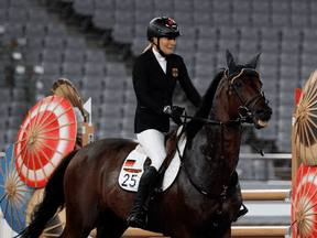 Annika Schleu of Germany cries after she couldn't get her horse to jump in the equestrian portion of the women's modern pentathlon at the 2020 Summer Olympics, in Tokyo, Japan, on Aug. 6, 2021. The horse was hit by a team coach.