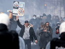 Protesters face police as clashes erupt during a demonstration against COVID-19 measures in Brussels on November 21, 2021.