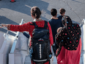 File photo of Afghan refugees arriving at Toronto Pearson International Airport in August.