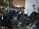 Afghan ex-employees of Canada, approved to immigrate here, gather outside the Kabul airport after the Taliban takeover, in hopes Canadian troops would escort them inside the airfield, early September 2021.