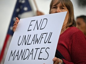 In this file photo taken on November 01, 2021, workers at NASA's Jet Propulsion Laboratory (JPL) and their supporters protest outside JPL in Pasadena, California against a US government mandate requiring all federal employees to received the Covid-19 vaccine.