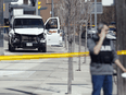 Police inspect a van involved in killing and injuring multiple people on Yonge Street on April 23, 2018 in Toronto.