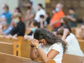 People attend a mass at Cathedrale Saint Maron in Montreal, on Aug. 9, 2020.