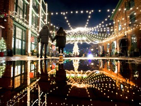Visitors to the historic Distillery District in Toronto take in the Christmas lights on Saturday, December 12, 2020.