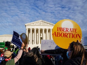 People rally outside the U.S. Supreme Court in Washington to keep abortion legal, on Dec. 1, 2021, as the court was hearing arguments regarding restrictive new Mississippi legislation that bans abortions after 15 weeks of pregnancy.