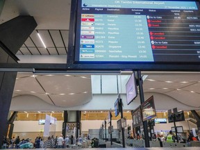 An electronic flight notice board displays cancelled flights at OR Tambo International Airport in Johannesburg on November 27, 2021, after several countries banned flights from South Africa following the discovery of a new Covid-19 variant Omicron. (Photo by Phill Magakoe / AFP)