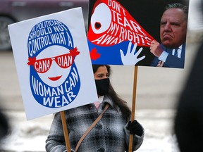A woman takes part in a protest against Quebec's Bill 21, outside Calgary city hall on Dec. 19, 2021.