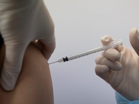 A nurse administers a vaccine shot of the Pfizer-BioNTech Covid-19 vaccine. Photographer: SeongJoon Cho/Bloomberg