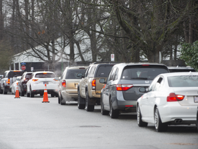 Vehicles wait in line to enter the North Vancouver Covid-19 Testing Centre in Vancouver, British Columbia, Canada, on Thursday, Dec. 16, 2021.