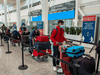 Passengers arriving at Pearson Airport in Toronto wait for transportation to their quarantine hotels, April 23, 2021.