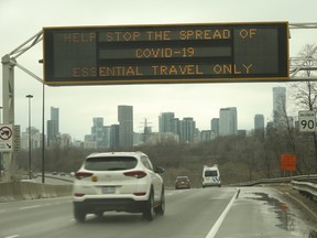 A travel advisory is displayed on a sign over the Don Valley Parkway in Toronto on March 28, 2020.
