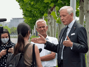 Dominic Barton, right, Canada's Ambassador to China, speaks to reporters after meeting with Michael Spavor at a detention center in Dandong, China, Aug. 11, 2021.