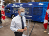 Innovation, Science and Industry Minister Francois-Philippe Champagne walks past a new electric bus during a tour of the Novabus plant on June 8, 2021 in St. Eustache, Quebec.