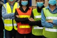 Group of factory industry workers working with face mask to prevent Covid-19