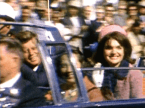 U.S. President John F. Kennedy and Jacqueline Kennedy ride in a motorcade in Dallas, Texas, moments before he was gunned down November 22, 1963.