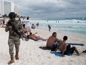 Members of the Navy patrol a beach resort  in Cancun, part of a program created by the provincial government of Quintana Roo, Mexico.