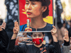 A pro-democracy activist holds an image of Myanmar’s ousted civilian leader Aung San Suu Kyi at a peace march in Tokyo on December 11, 2021.