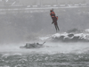 A U.S. Coast Guard rescue diver removes a passenger from a vehicle in the water at the brink of Niagara Falls, N.Y. on Dec. 8, 2021.