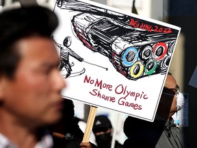Protesters demonstrate outside the NBC Sports office in San Francisco, Calif., on Dec. 10, 2021, to demand that the network not broadcast the 2022 Winter Olympic Games from Beijing, China, due to the country's human rights abuses. Canada has announced a diplomatic boycott of the Games, but readers say that's not enough.