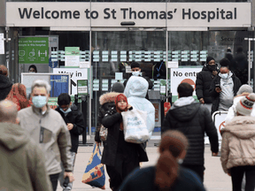 People outside St Thomas' Hospital in central London on December 23, 2021.