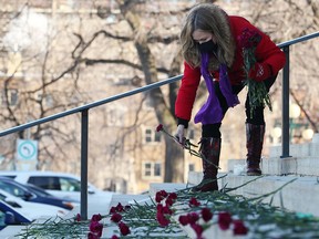 Nicki Dewar, whose 31-year-old daughter, Kristin, died of an opioid overdose, places carnations on the steps of the Manitoba Legislative Building in Winnipeg on Nov. 24, 2021, during National Addictions Awareness Week. A new StatCan report reveals that as the pandemic stretches on, it’s younger Canadians who are disproportionately dying, largely due to unintentional overdoses and poisonings.