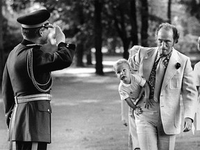 Pierre Trudeau carries toddler Justin Trudeau past a saluting Mountie in 1973.