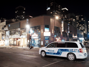Police patrol Sainte-Catherine street in Montreal on January 9, 2021, the first night of a curfew due to rising COVID-19 cases.