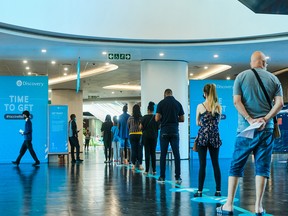 Visitors queue for vaccines at the Discovery Ltd. Covid-19 vaccination site in Johannesburg, South Africa, on Thursday, Dec. 9, 2021.