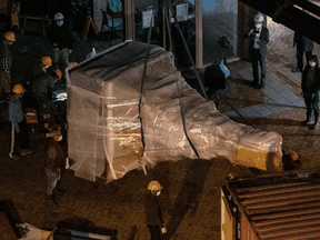 Workers at the University of Hong Kong remove a section of the 'Pillar of Shame' statue by Danish artist Jens Galschiot that commemorates the victims of the 1989 Tiananmen Square massacre in Beijing, December 23, 2021.