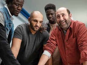 Kad Merad (far right) leads a group of convicts in a theatre class in The Big Hit.