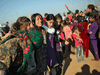 Yazidi refugees celebrate news of the liberation of their homeland of Sinjar in northern Iraq from ISIL extremists, while at a refugee camp in Syria on November 13, 2015. The Islamic State captured Sinjar in August 2014, killing many and sexually enslaving thousands of Yazidi women.