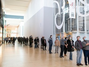 A lengthy queue snakes though Toronto's Yorkdale Mall as people wait to receive a free COVID-19 rapid antigen test kit at a pop-up site at the shopping complex, on Thursday, December 16, 2021.THE CANADIAN PRESS/Chris Young