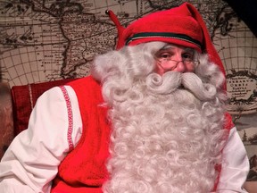 A man dressed as Santa Claus is pictured in his chamber at the Santa Claus Village in the Arctic Circle near Rovaniemi, Finland, Dec. 2021.