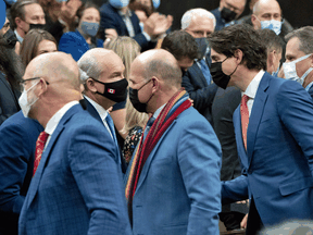 Prime Minister Justin Trudeau, with Justice Minister David Lametti, left, Tourism Minister Randy Boissonnault and Government House Leader Mark Holland cross the floor of the House of Commons to shake hands with Conservative leader Erin O'Toole and other MPs after the unanimous adoption of legislation banning conversion therapy, December 1, 2021.