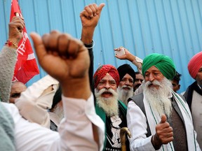 Farmers celebrate long-running protests being called off, after the government agreed to their demands, including assurances to consider guaranteed prices for all produce, at the Singhu border protest site near the Delhi-Haryana border, India, on Dec. 9, 2021.