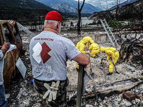 A Team Rubicon 'Greyshirt' leads a recovery effort in support of Lytton First Nation resident.