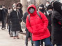 People wait at a walk in PCR COVID-19 test site in Toronto on  December 22, 2021.  Many had been in line for more than two hours.