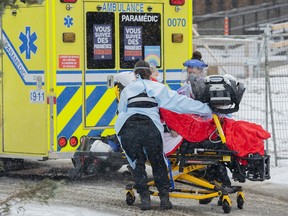Paramedics transfer a person from an ambulance into a hospital in Montreal, Sunday, Jan. 9, 2022. The Health Department says data from the last 24 hours indicates a 140-jump in hospitalization from the previous day, for a total of 2,436. The province is also reporting 11,007 new cases of COVID-19. THE CANADIAN PRESS/Graham Hughes ORG XMIT: GMH108-20220109_2022010917