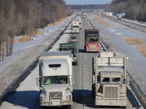 Tractor trailers proceed westbound on Hwy. 401 on January 26, 2022, near Summerstown, Ont., on a route that will only get busier over the next few days as Freedom Convoy 2022 arrives in Ottawa.