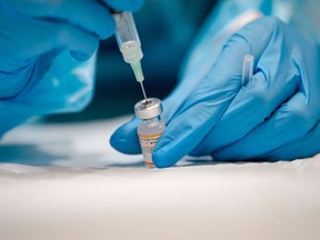 A nurse prepares the Pfizer-BioNTech Covid-19 vaccine in Montreal, Quebec on November 24, 2021. Pfizer Inc and BioNTech SE announced on Tuesday that they have a plan to study the safety and tolerability of a new shot that targets the Omicron variant.