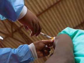 A teenager gets his first jab of the Covid 19 vaccine on December 15, 2021 in Chinhoyi, Zimbabwe.