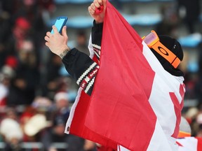 Gold medal winner Sebastien Toutant of Canada takes a selfie on the podium with silver medalist Kyle Mack of the USA and bronze medalist Billy Morgan of GBR at the Alpensia Ski Jumping Centre during the 2018 Winter Olympics in South Korea, February 24, 2018