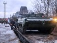 A Russian troop train transporting military vehicles arrives in Belarus on Jan. 18.